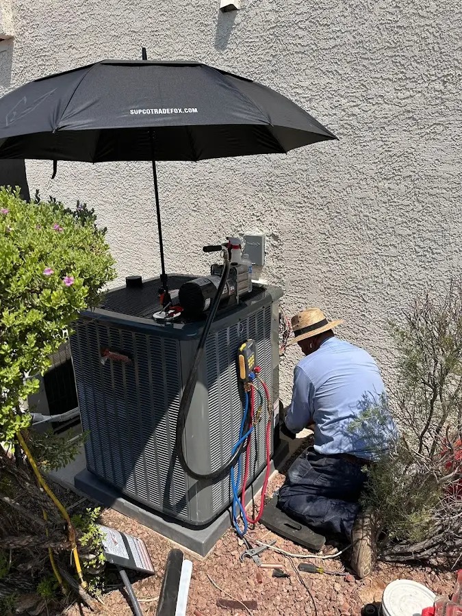 HVAC technician performing outdoor AC maintenance in El Cerro Mission