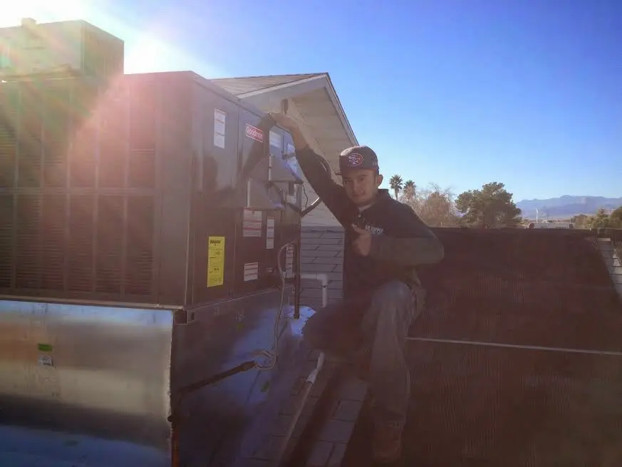 HVAC technician performing HVAC Inspection on a rooftop unit in El Cerro Mission